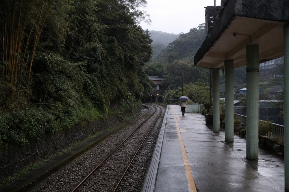 Mountain railway line curving along a forested valley in northeast Taiwan