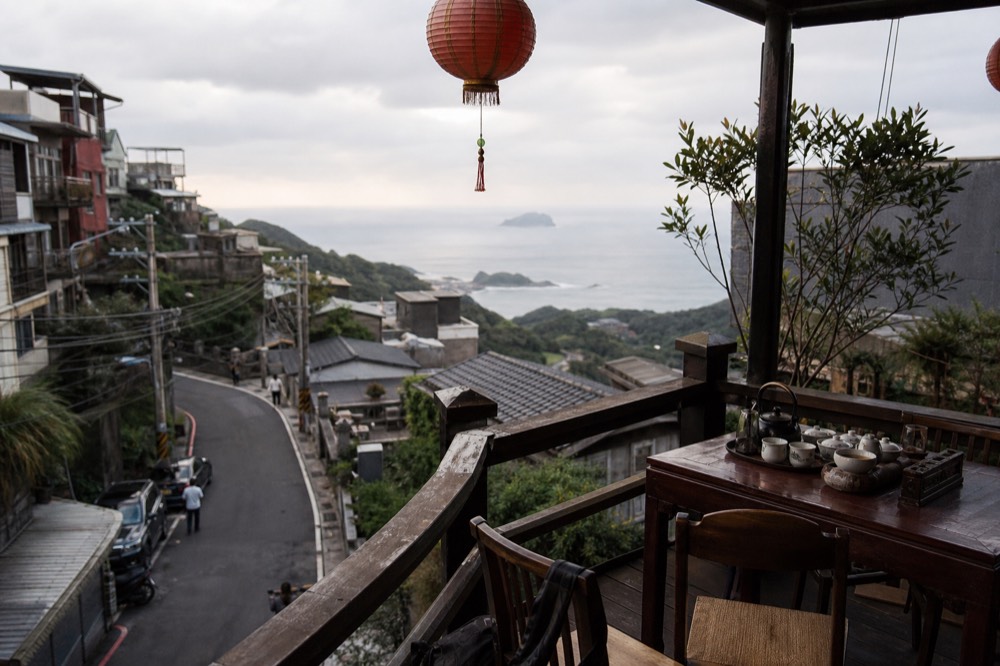 Teahouse terrace overlooking the coast from a hillside town