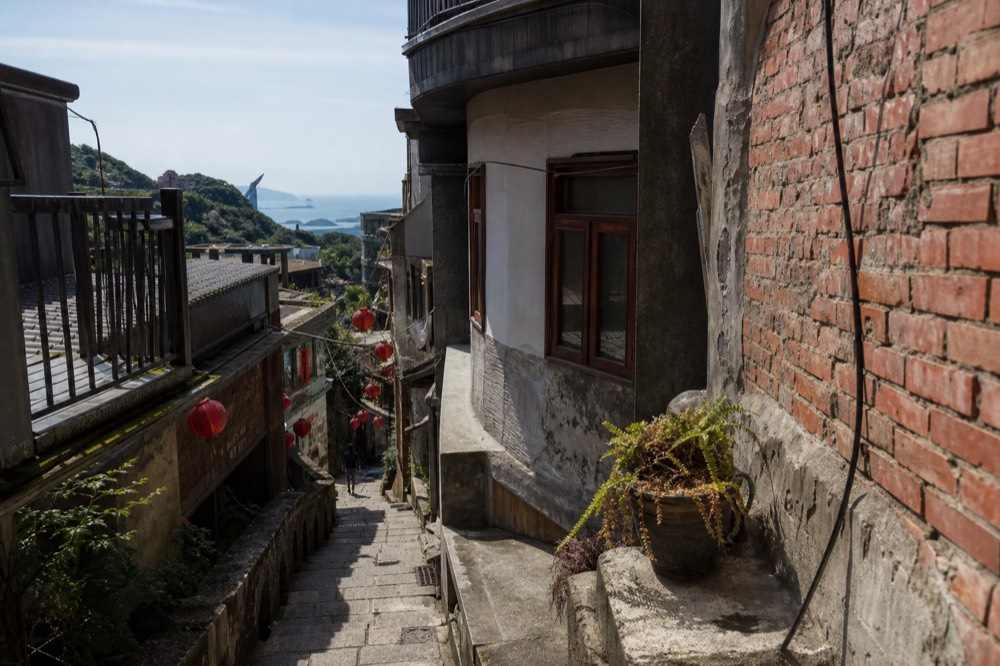Cliffside buildings and a curved stone stairway in a hill town