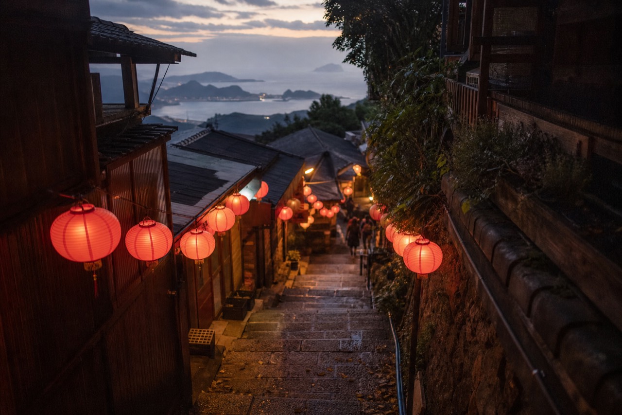 Lantern-lit stone steps of a hillside Taiwanese old street at dusk